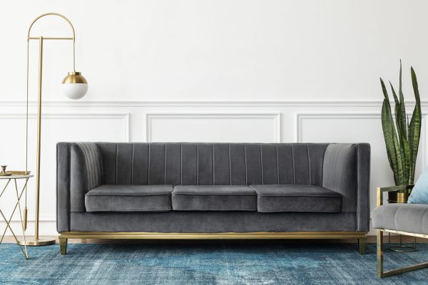 Chic mid-century modern luxury aesthetics living room with gray Chic mid-century modern luxury aesthetics living room with gray velvet couch and blue rug