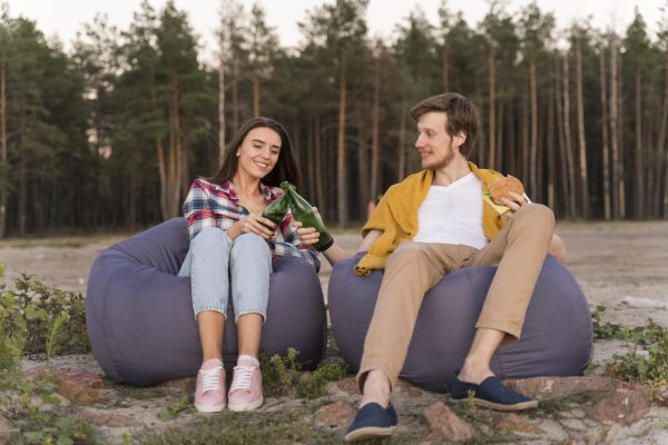 front-view-friends-outdoors-having-beers-beanbags front-view-friends-outdoors-having-beers-beanbags